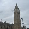 The bell tower at the Houses of Parliament set against gray skies.