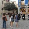 3 students walking through a plaza