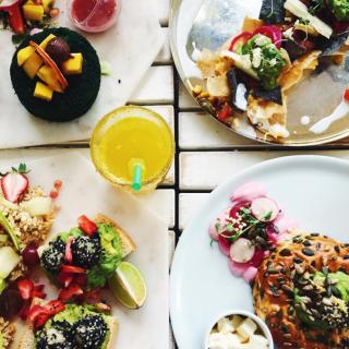 bright colorful foods on many dishes viewed from above