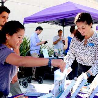 Student gathering study abroad information at a college fair