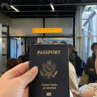 A student holds their passport as they wait in line to board their plane.