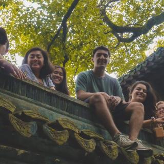 students looking down from a japanese house 