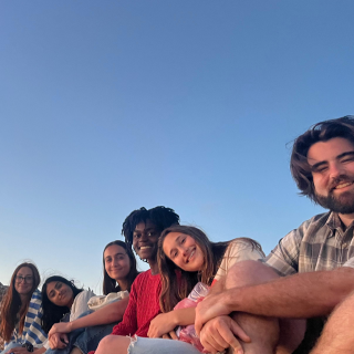 Students smiling in Rabat Morocco in front of a sunset