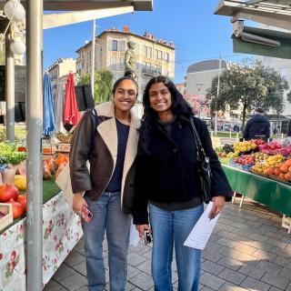 Two students smiling at a market in Nice, France