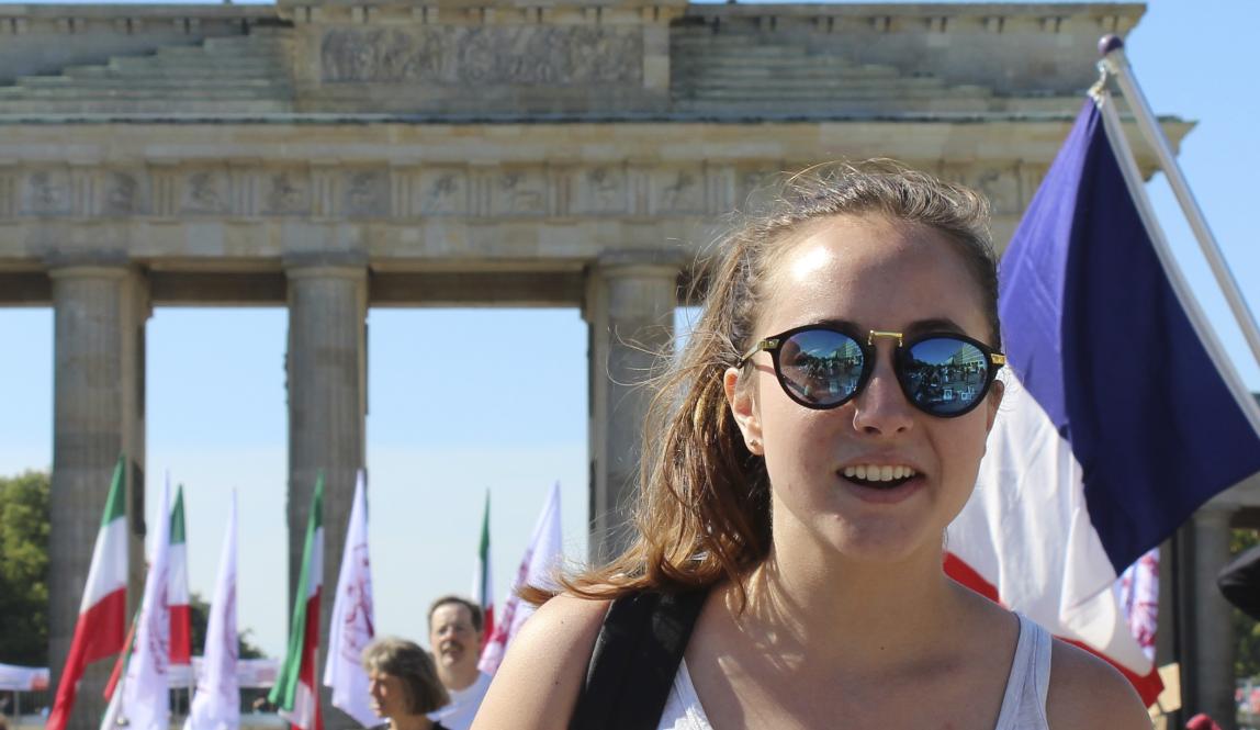 student posing in front of Brandenburg Gate in Berlin