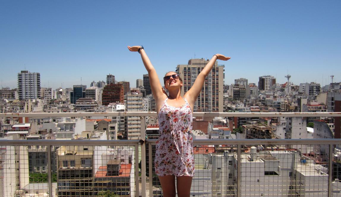 a student poses for a fun photo at the top of a building in Buenos Aires