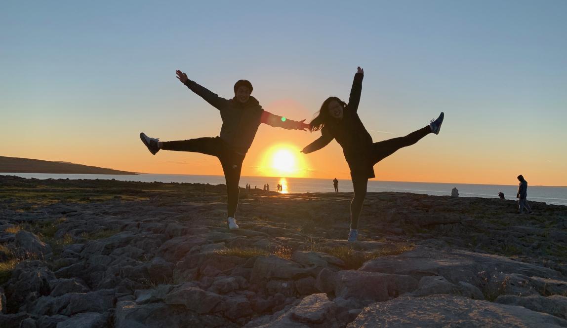 two students pose for a fun photo at sunset in Ireland