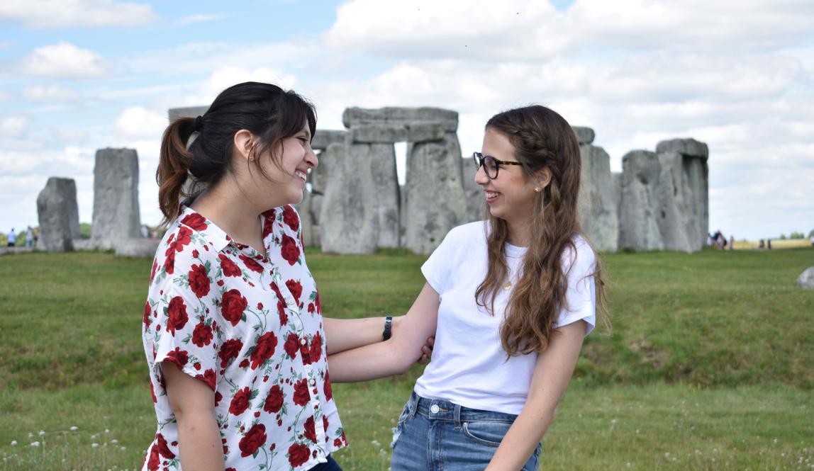 two good friends pose for a photo at Stone Henge