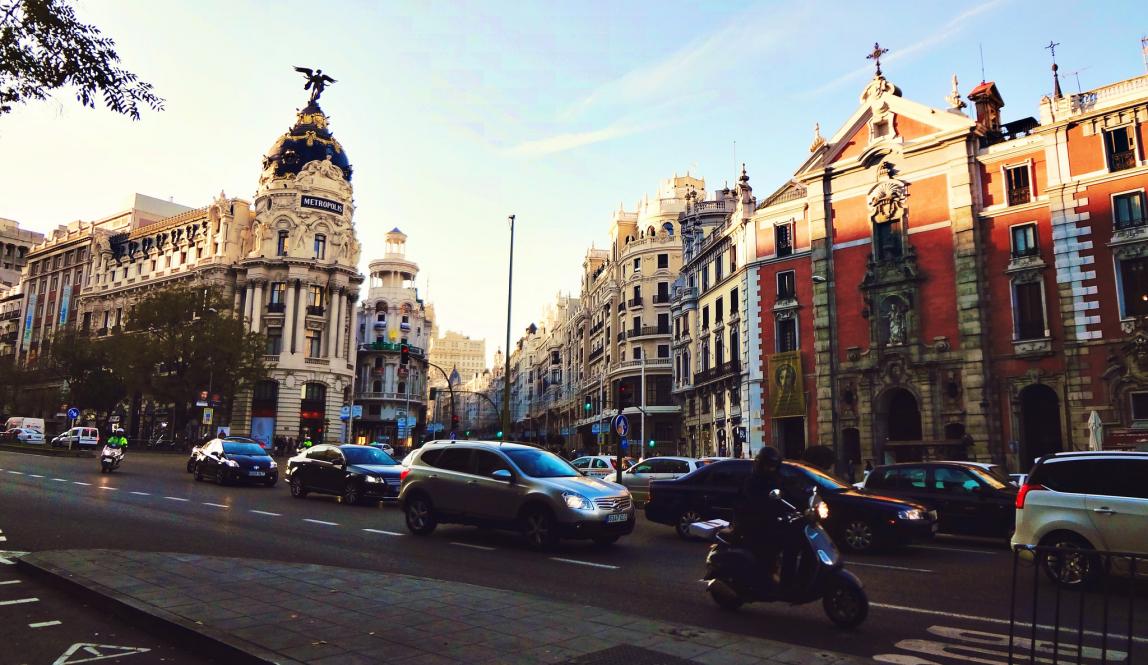 cars drive down a Madrid street