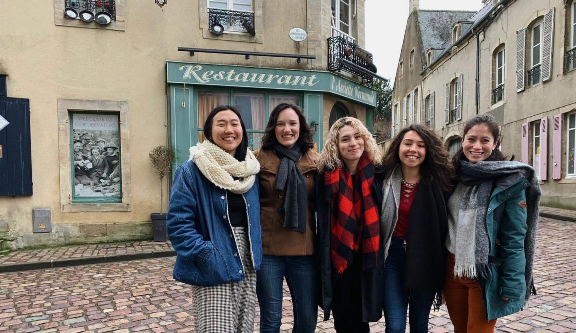 a group of students pose for a photo on the cobblestone streets of Nantes