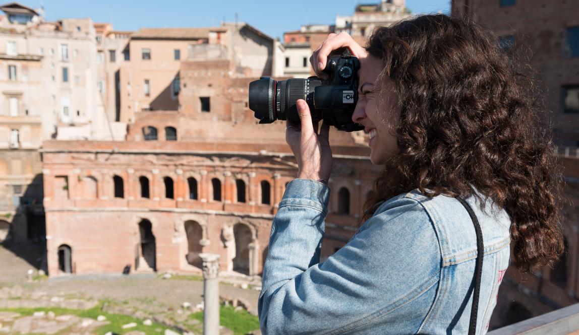 a student takes a photo of the Roman Forum in Rome