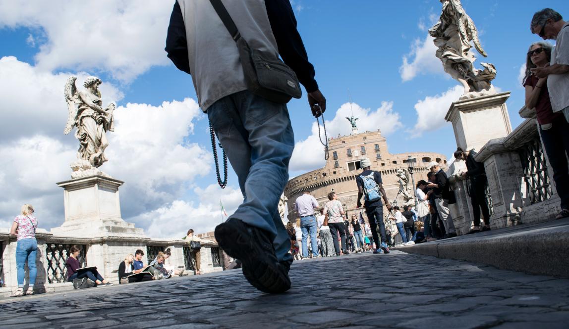 an artistic shot of people's feet as they walk toward Castel Sant'Angelo