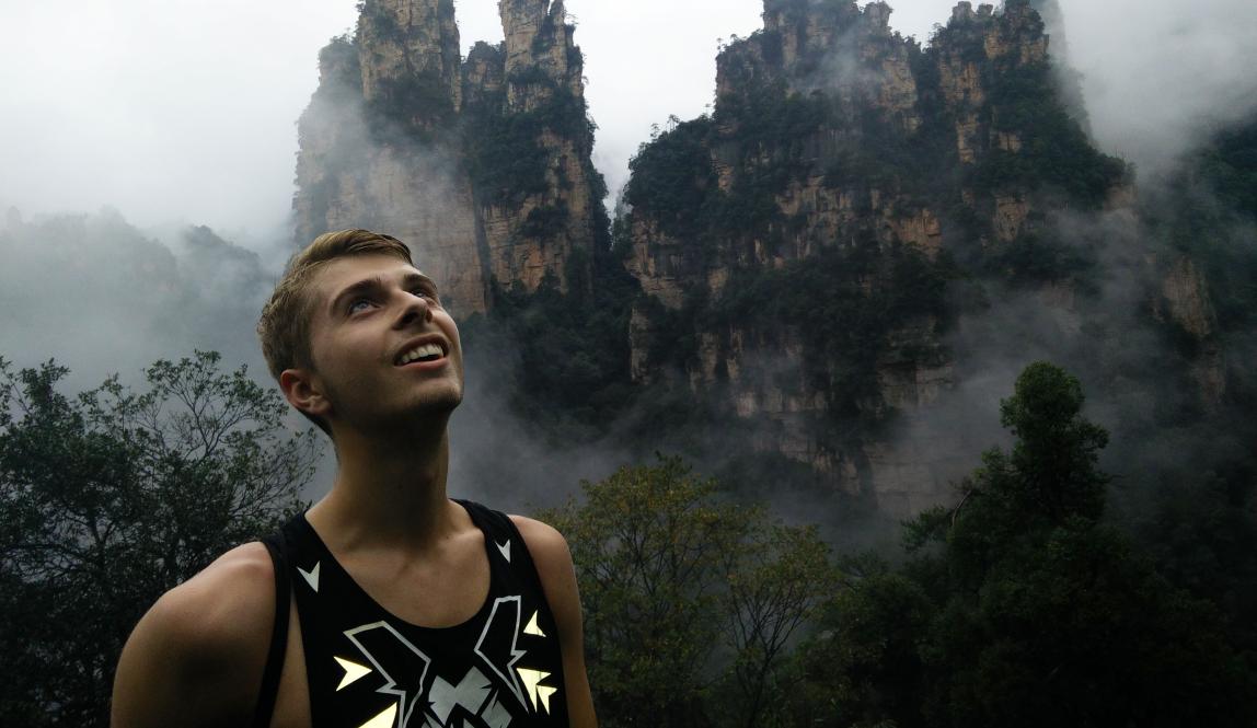 a student looking up at the mountains at Zhangjiajie National Forest Park