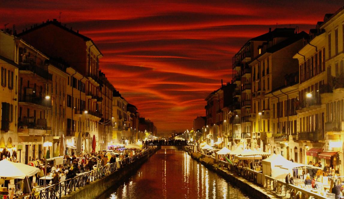 a stunning shot of a canal in Milan just after sunset