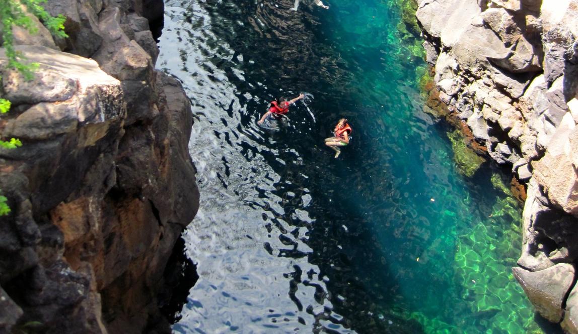 students swimming in Las Grietas on Isla San Santa Cruz