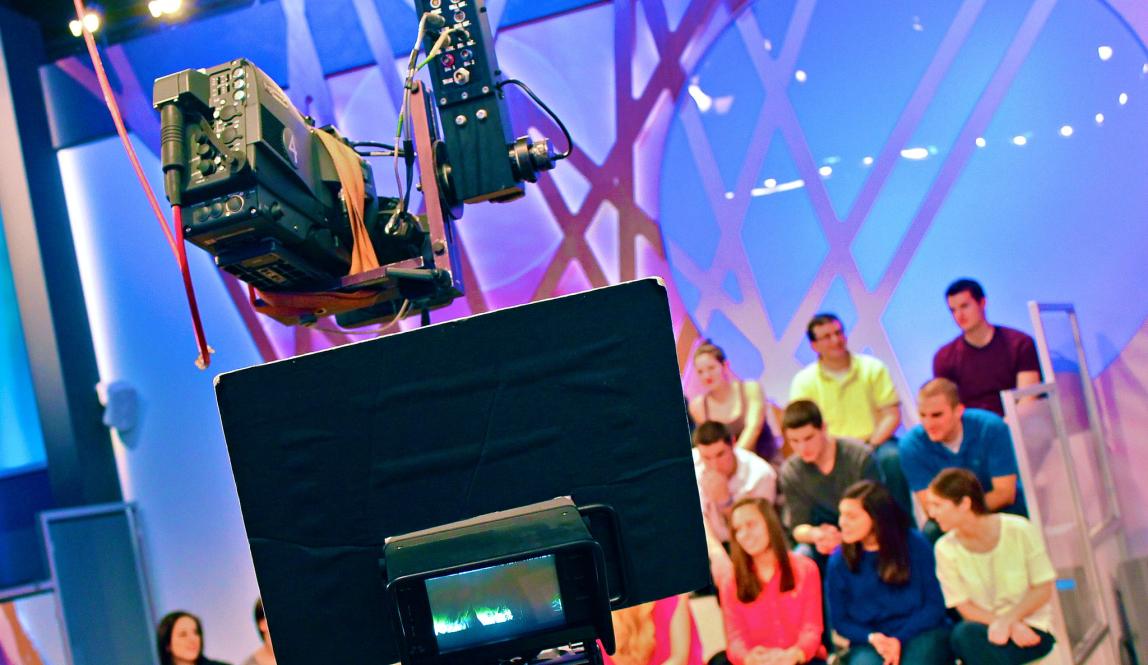a studio audience behind a camera in Milan