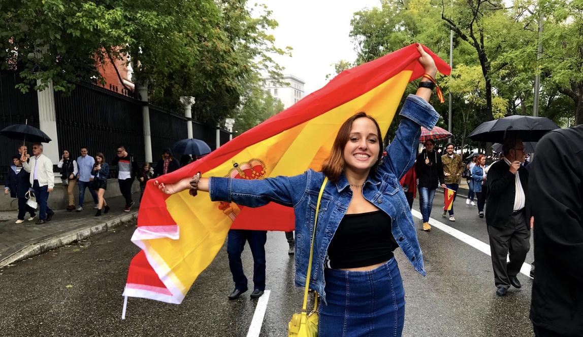a student holding a Spanish flag to celebrate Dia de la Hispanidad