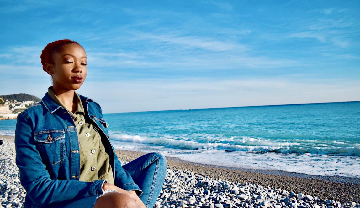 Female student meditating on the Promenade des Anglais
