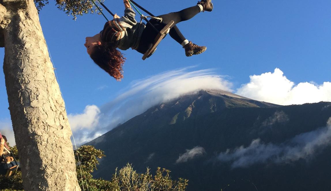 a student swinging in the mountains of Baños at Casa del Arbol