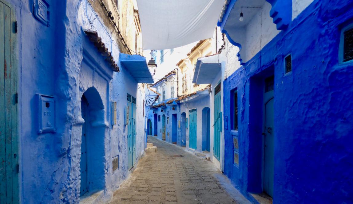 A street of blue buildings in Chaouen, Morocco.