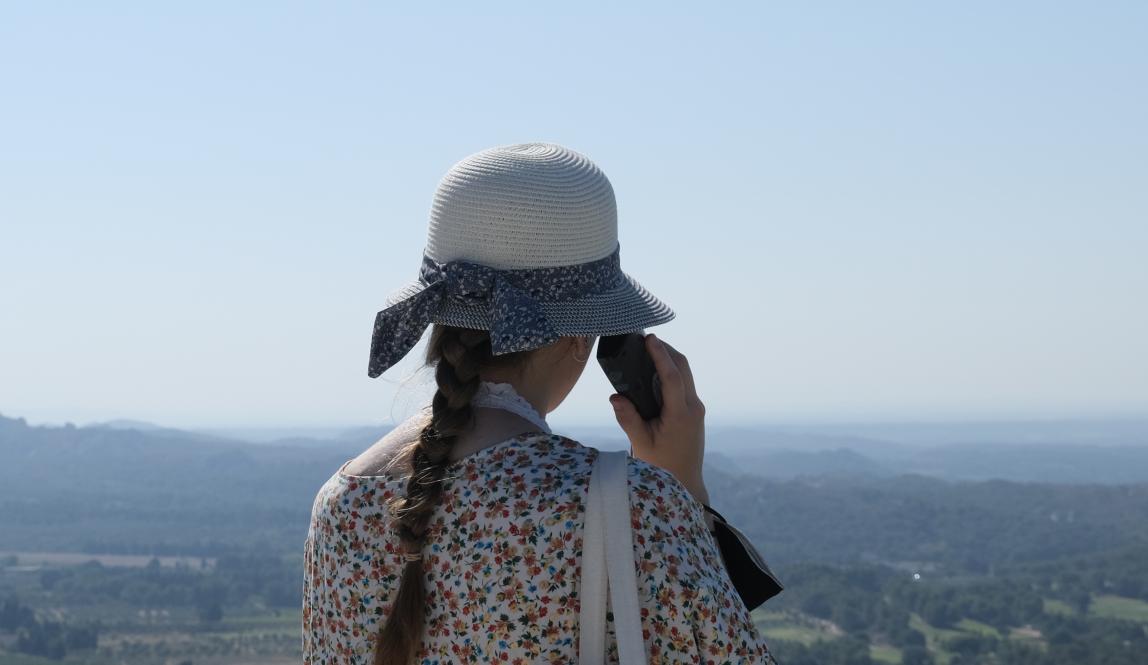 A student looks out over the green landscape of Beaux de Provence, France.