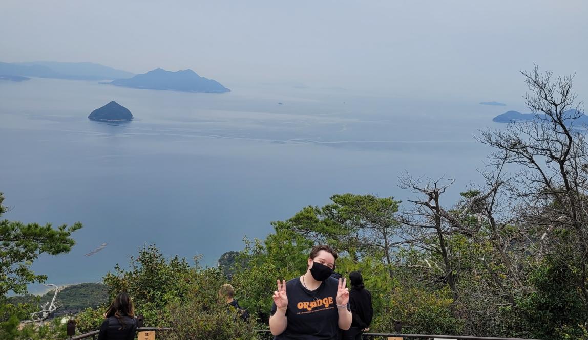 Author, Macks, posing at the top of a mountain at Itsukushima Shrine.
