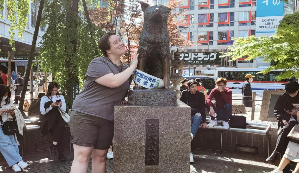 Author, Macks, posing with Hachiko at Shibuya Crossing in Tokyo.