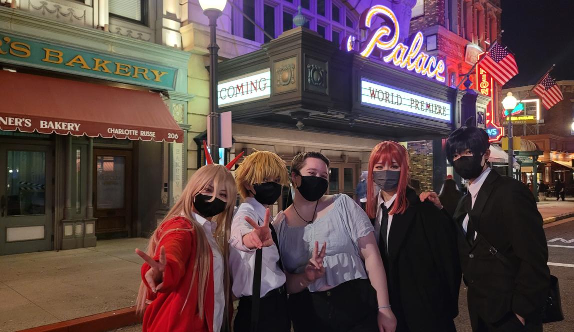 Author, Macks, posing with Chainsaw Man cosplayers at Universal Studios, Japan.