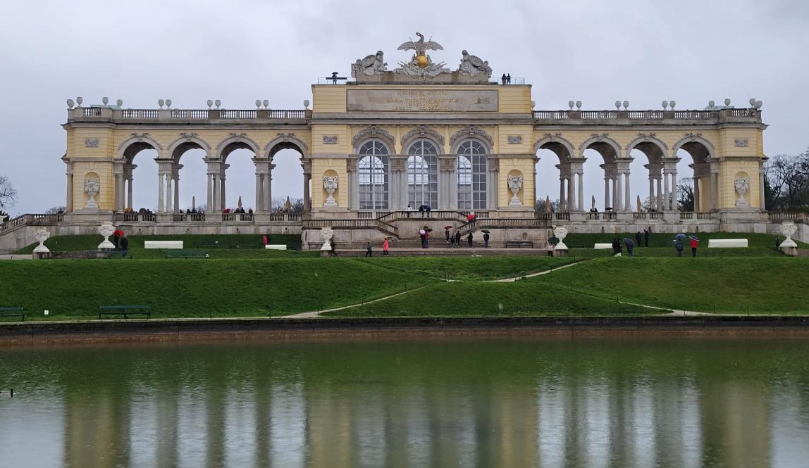 Shown is a monument at the Schonbrunn Palace by a small pond