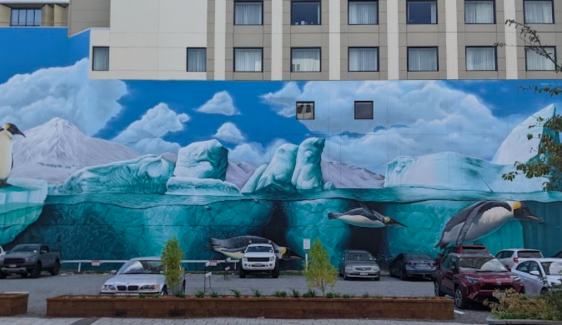 Mural of penguins sitting on chunks of floating ice and diving into the water