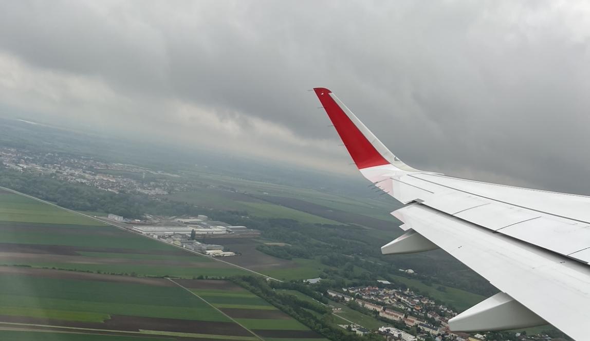 view from plane window as airplane departs vienna