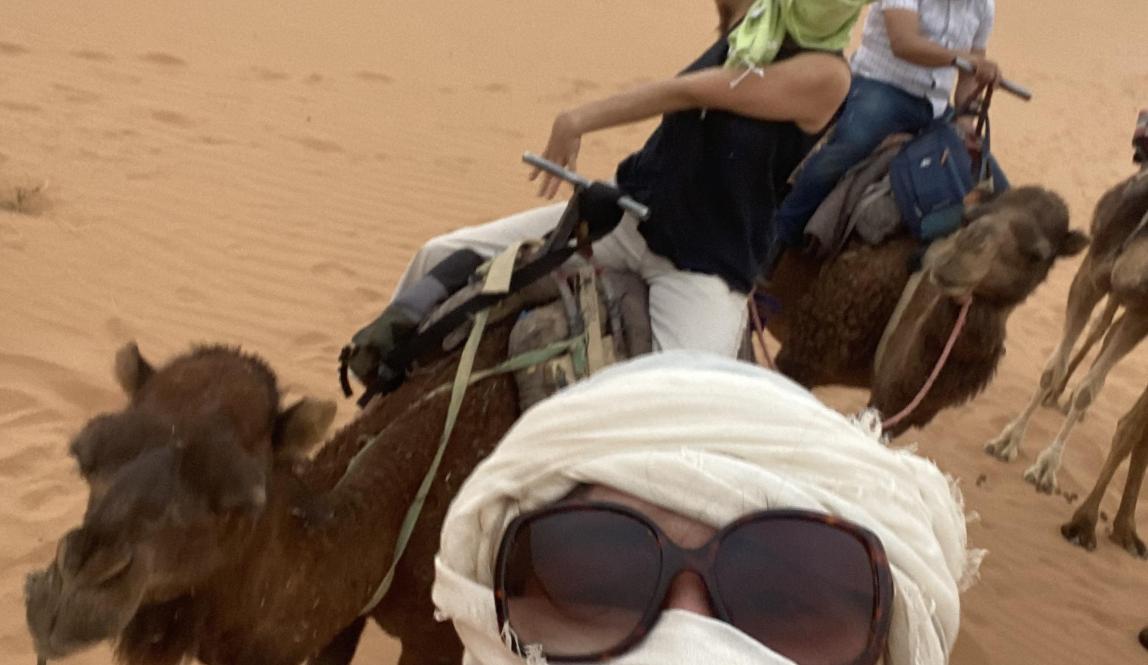 A girl taking a selfie on a camel