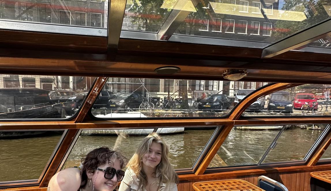 Two people in a boat in the Amsterdam canal