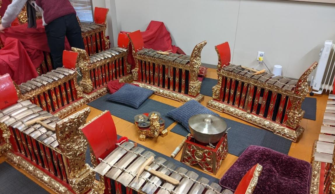 Red and gold xylophone-like instruments of different sizes with a small gong and chimes in the middle