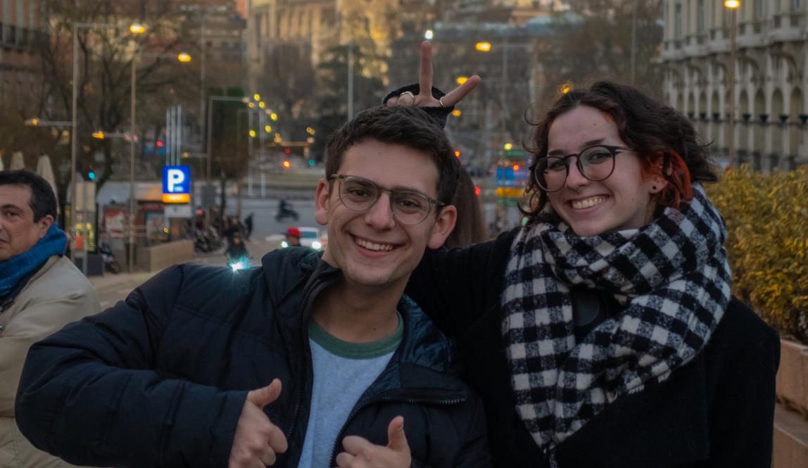 Two students smile on a street in Madrid, Spain.