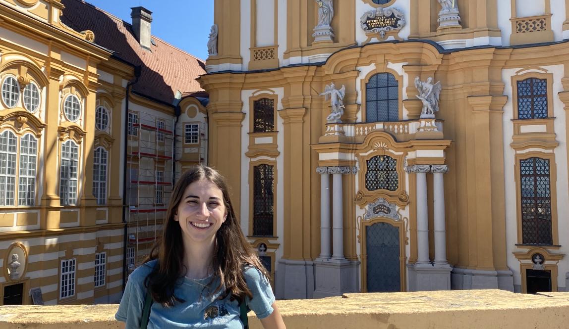 Girl smiling at camera in front of the Abbey at Melk