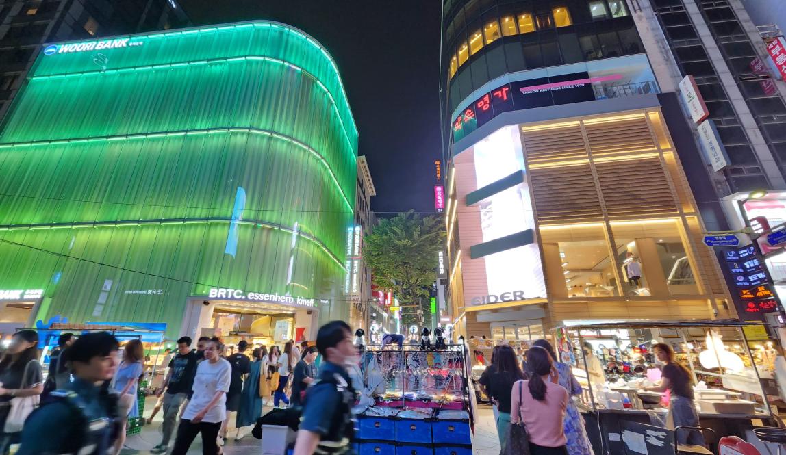 Photo of a busy city street in a shopping district in Seoul, South Korea