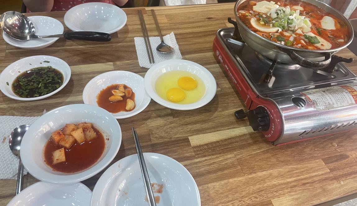 Image of Tofu Soup and Sides at Korean Restaurant 