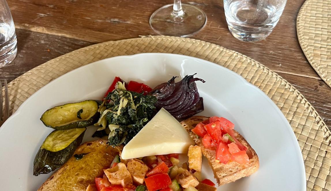 Plate of lactose-free cheese, veggies, meat, and crackers at a local winery in Tuscany 