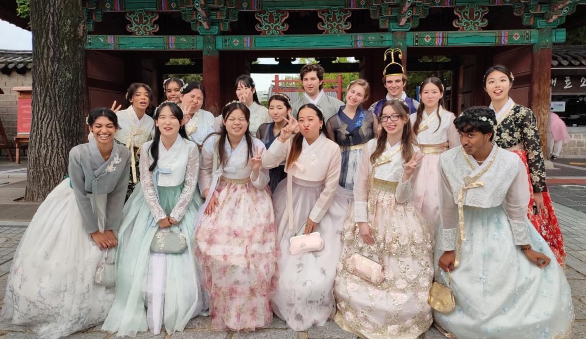 Image of IES students wearing traditional Korean dress, Hanbok, in front of a shrine 