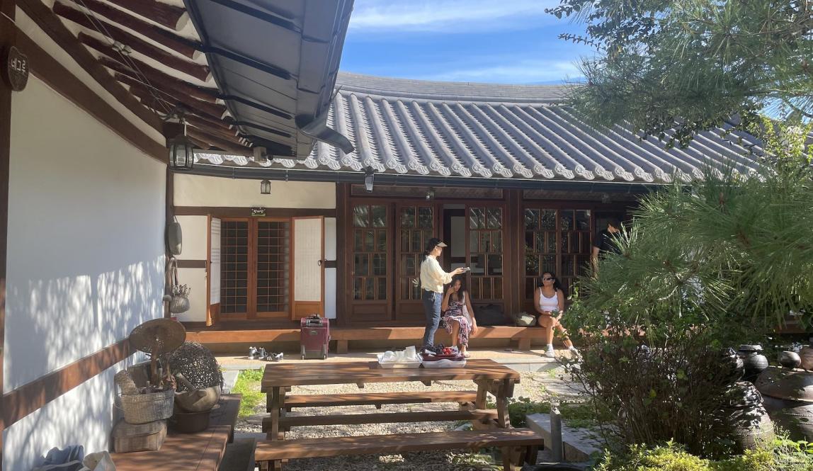 Image of hanok, traditional Korean home, with students in background 