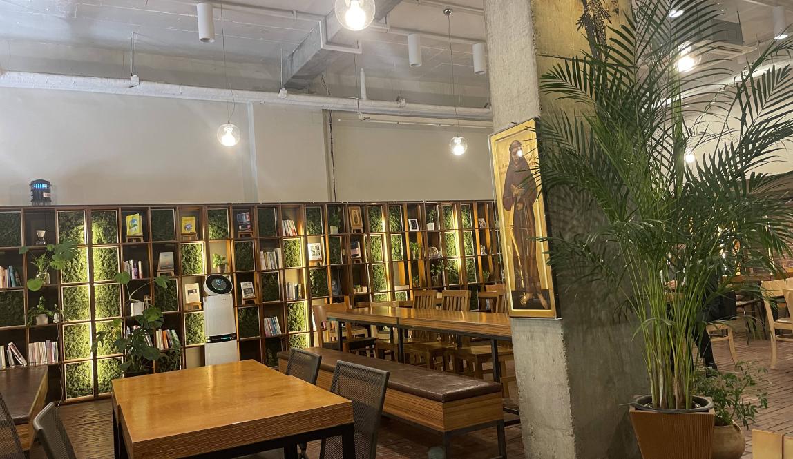 Image of cafe with tables and book shelves 