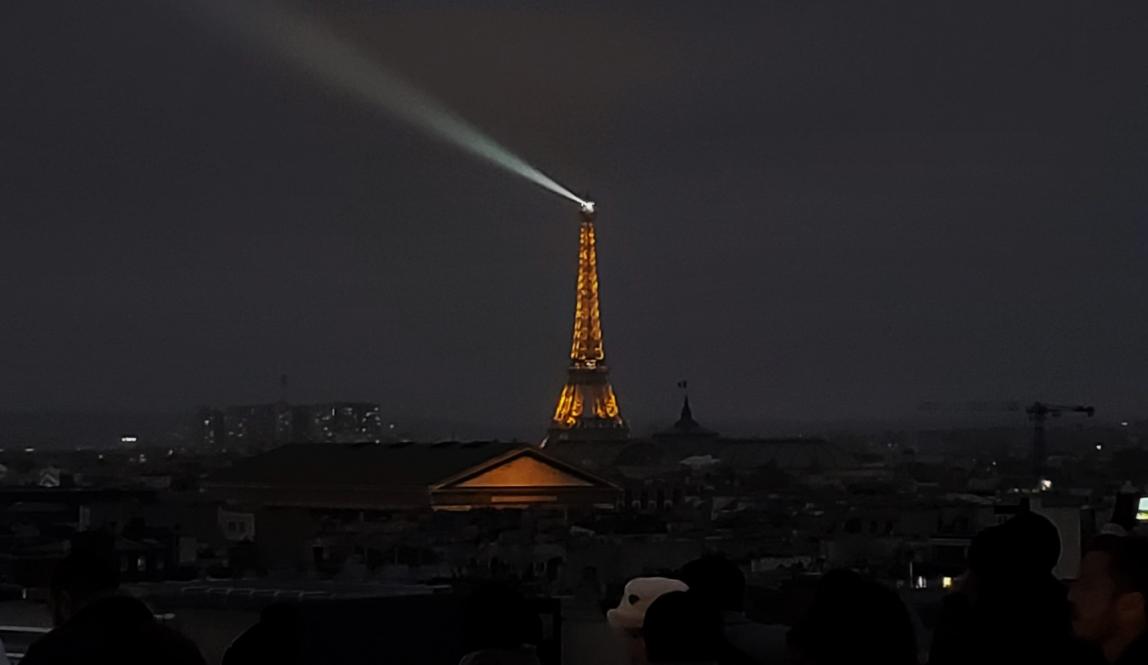 The Eiffel Tower lit up from the top of the Galerie de Lafayette.