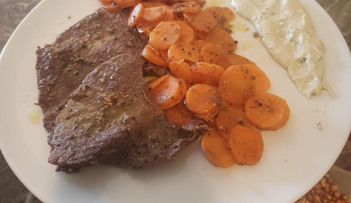 Three steaks lovingly prepared with a side of carrots and healthy side of Roquefort sauce. *chef's kiss*