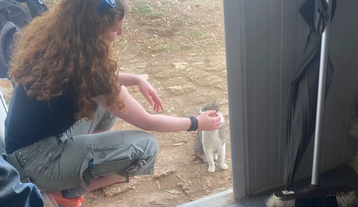 Ginger lady petting a cat and losing her mind over it... internally obviously