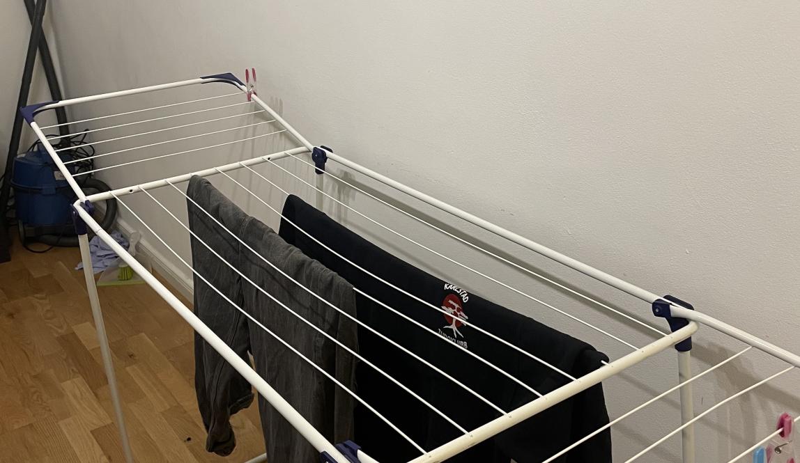 A drying rack with some clothes on it
