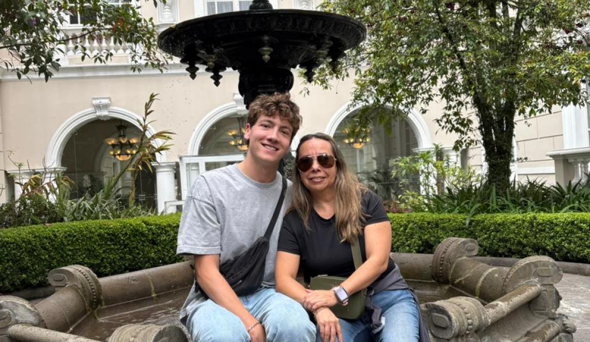 My host mother and I sitting on the ledge of a fountain in the middle of a garden in Quito.