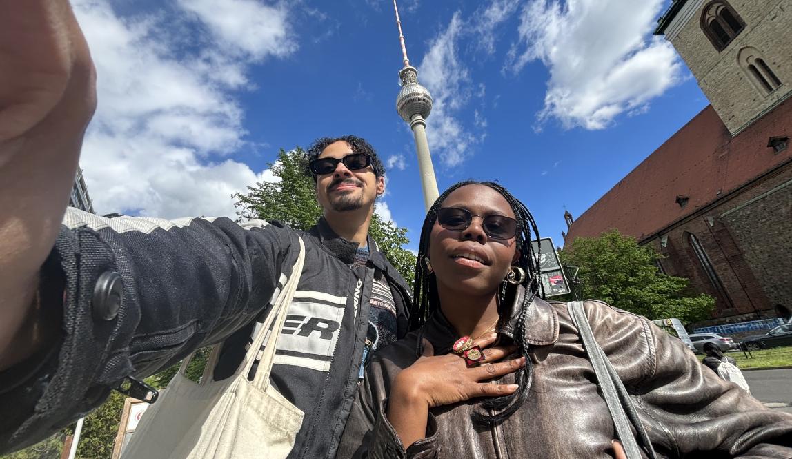 Myles and a friend take a low-angle selfie with the blue sky in berlin.