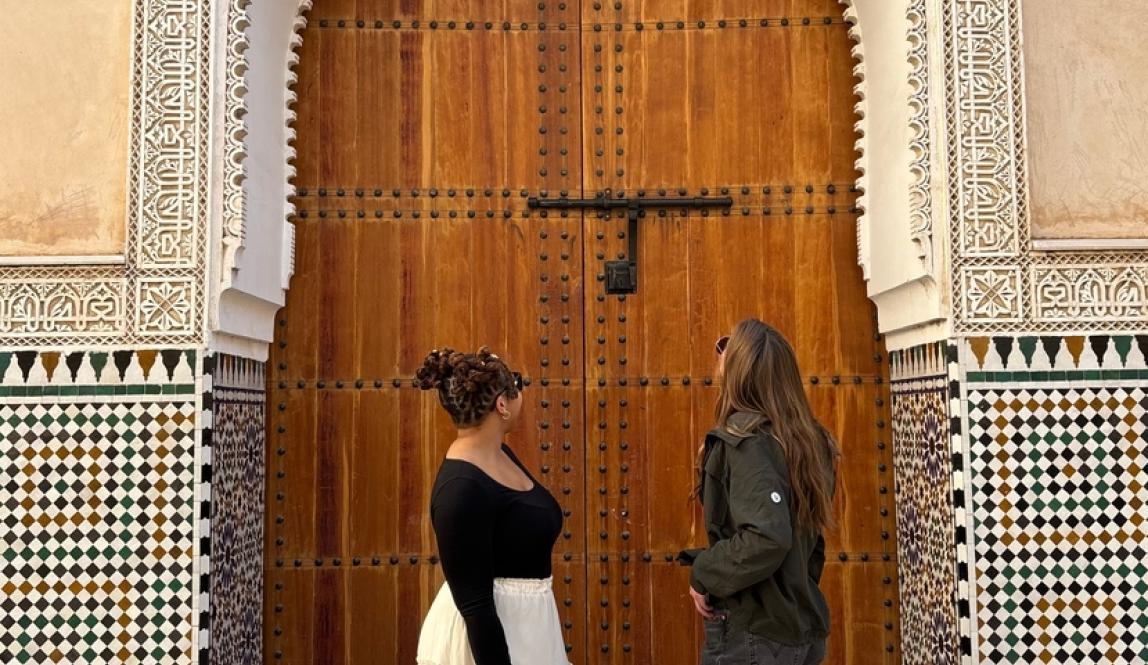 Two Female Students in Rabat's Medina Looking Upwards