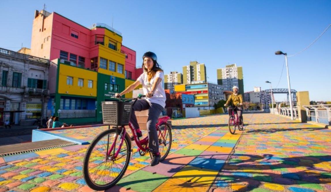 student riding bike in colorful street of Buenos Aires